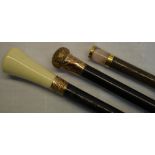 Three walking stick in dark wood, one engraved copper knob, one copper banding and concave bone top,