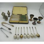 Cased set of five green handled knives, eight apostle tea spoons, salt and pepper set, two pairs