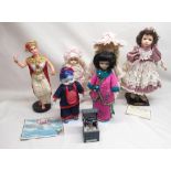 Six large dolls and a small doll in a box