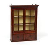 Property of a lady - a mahogany glazed two-door wall cabinet with two drawers under, parts 19th
