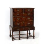 Property of a lady - an early 18th century walnut & banded chest on stand, 37.5ins. (95cms.) wide (