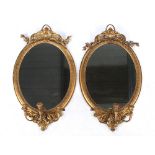 Property of a lady - a pair of late Victorian gilt oval framed girandoles, each approximately 36ins.