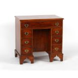 Property of a deceased estate - a reproduction yew wood kneehole desk of small size, 29.5ins. (