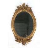 Property of a lady - a Victorian gilt oval framed wall mirror, with cherub & fern leaf
