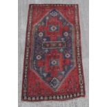 A Belouch woollen hand-made rug with blue ground, 85 by 46ins. (216 by 117cms.).