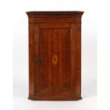 Property of a deceased estate - a George III oak corner wall cupboard with inlaid fan motif,