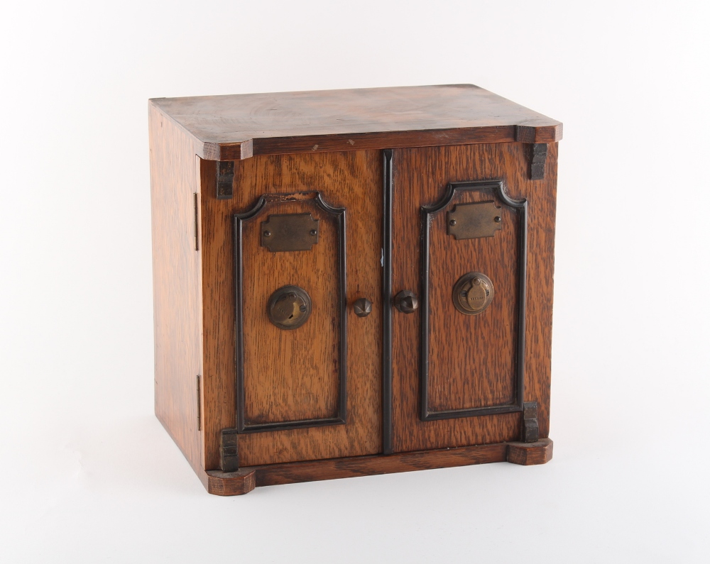 Property of a gentleman - an early 20th century oak coin collector's cabinet, enclosing 20 sectioned