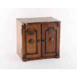 Property of a gentleman - an early 20th century oak coin collector's cabinet, enclosing 20 sectioned