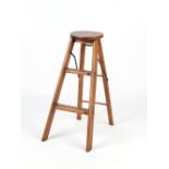 Property of a gentleman - an early 20th century oak circular topped folding step ladder stool.