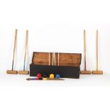 Property of a lady - a vintage croquet set, in stained pine box, the box 41.5ins. (105.5cms.) long.