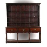 Property of a gentleman - a George III oak two part dresser, of good colour, the base with three