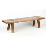 Property of a gentleman - a large antique elm pig bench, of good colour, 73ins. (185cms.) long.