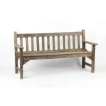 Property of a lady - a teak garden bench, by R.A. Lister & Co. Ltd., 62.5ins. (159cms.) long.