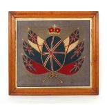 Property of a gentleman - militaria - a 19th century woolwork military coat of arms, in glazed maple