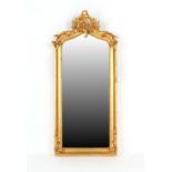 Property of a lady - a giltwood framed wall mirror with rocaille cresting & bevelled glass,