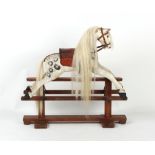 Property of a lady - a late 19th / early 20th century painted rocking horse, 35.5ins. (90cms.) long,