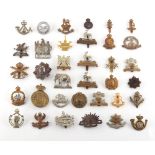 Property of a deceased estate - a collection of military cap badges, mostly QV - WWI, including