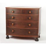 An early 19th century mahogany bow-fronted chest of two short & three long drawers, on fluted bun