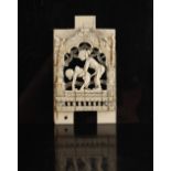 A 19th century Indian carved ivory erotic panel, 3.95ins. (10cms.) high.