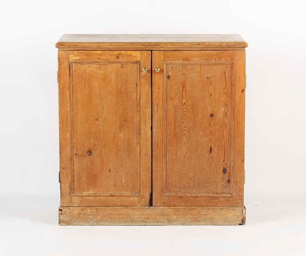 Property of a gentleman - a Victorian pine panelled two-door cupboard on plinth base, the base