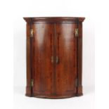 Property of a lady - an 18th century George III oak & mahogany bow-fronted corner wall cabinet