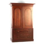 A Victorian mahogany two-part linen press, with fielded arched panelled doors enclosing four short