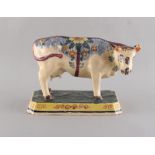 Property of a deceased estate - a 19th century Dutch polychrome Delft model of a cow, 7.9ins. (