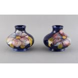 Property of a deceased estate - a small pair of Moorcroft vases, each 2.75ins. (7cms.) high (2).