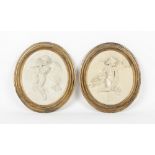 Property of a gentleman - a pair of Victorian painted plaster oval relief plaques depicting cherub