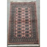 Property of a lady - a modern Tekke design hand knotted rug, signature to one end, 61 by 37ins. (155