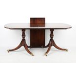 Property of a gentleman - a reproduction mahogany twin pillar dining table, with extra leaf.