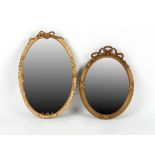 Property of a lady - two gilt oval framed wall mirrors, the larger 29.5ins. (75cms.) high (