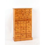 Property of a deceased estate - a modern pine bank of 30 drawers of various sizes, 45.5ins. (115.