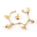 Property of a deceased estate - a 9ct gold charm bracelet with six 9ct gold charms (one detached),