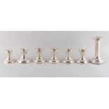 Property of a gentleman - a group of seven silver dwarf candlesticks including two matching pairs,