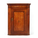 Property of a gentleman - a George III oak & mahogany corner wall cabinet with inlaid vase of