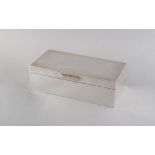 Property of a deceased estate - a Garrard silver cigarette box, 6.5ins. (16.5cms.) long.