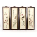 A set of four early 20th century Chinese embroidered silk pictures of birds among flowers, in