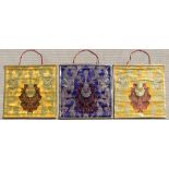 A set of three Tibetan embroidered silk & metal thread wall hangings, each 26.8 by 25.4ins. (68 by