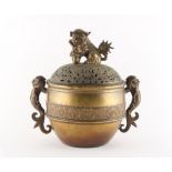 A large bronze censer, 19th century, the pierced cover with temple lion finial, previously with