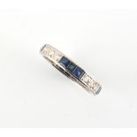 A platinum sapphire & diamond eternity ring, set with alternating rows of three square cut sapphires