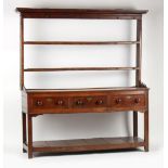Property of a lady - a George III oak two-part dresser with three drawers above pot board, 71ins. (