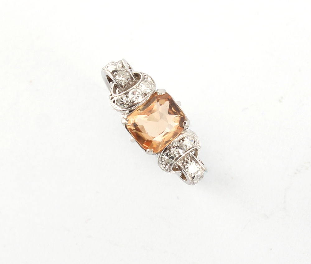 An early 20th century white metal (probably platinum) topaz & diamond ring, with ornately pierced
