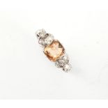 An early 20th century white metal (probably platinum) topaz & diamond ring, with ornately pierced