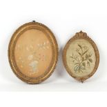 Property of a deceased estate - two silkwork oval pictures depicting flowers, in glazed gilt oval