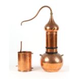 A copper alembic perfume still, 42.5ins. (108cms.) high. Provenance - L'Occitane, Salisbury.