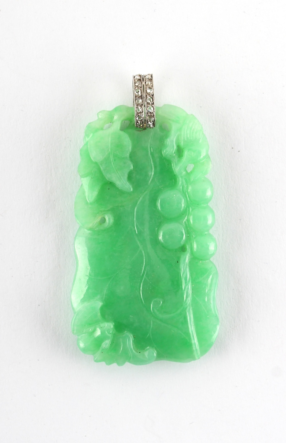A very good Chinese carved natural jadeite pendant with diamond set suspension loop, the evenly