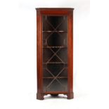 Property of a gentleman - a 19th century mahogany freestanding corner display cabinet with dentil