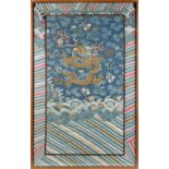 A 19th century Chinese kesi panel depicting a dragon chasing a flaming pearl above waves,