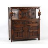 Property of a deceased estate - a reproduction carved oak court cupboard, 49ins. (124.5cms.) long.